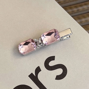 Detail of pink crystal hair clip with silver alloy base and sparkling rhinestone inlay