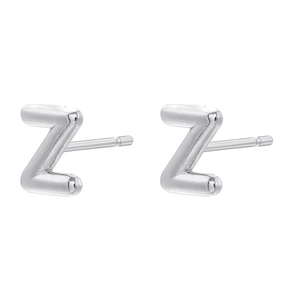 Detailed view of silver finish Z-shaped stud earrings in a minimalist style