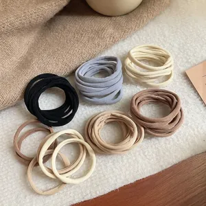 Set of 6 elastic fabric hair ties in earthy tones like black, grey, and beige