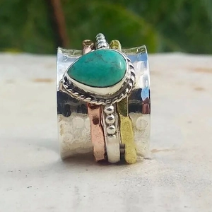 Anillo spinner bohemio con bandas de plata martillada, cobre y una turquesa de pera