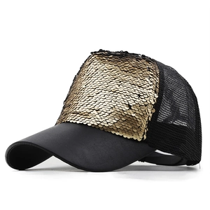 Detailed side view of black baseball cap with sparkling gold sequins and mesh fabric