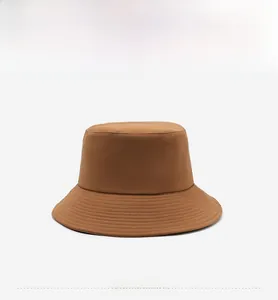 Close-up of brown bucket hat with reinforced stitching and flat top crown detail