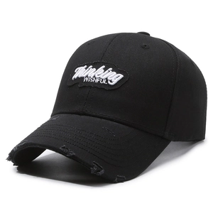 Distressed black cotton baseball cap with Thinking WISHFUL patch and frayed brim style
