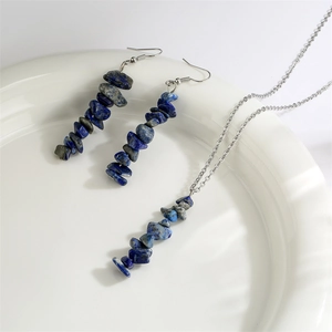Detail of silver chain jewelry set with dark blue natural stone chips and tassels