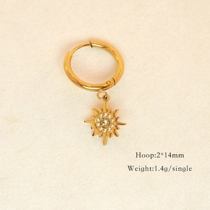 Detailed view of 14K gold plated hoop earring with sun pendant and tiny crystals