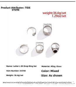 Detailed view of vintage silver alloy rings featuring letter L engraving and glass inlay
