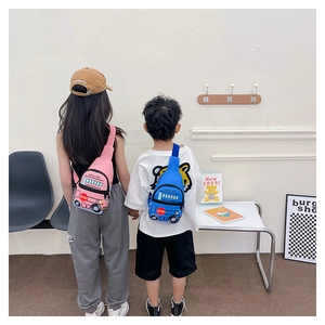Kids school bus chest bags in pink and blue shown being worn in a bright room