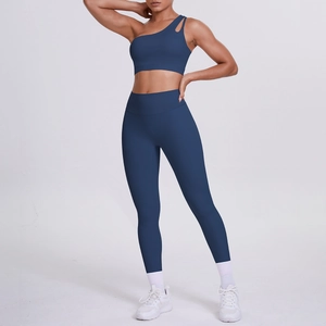 Detail of dark blue one-shoulder sports bra and high-waist leggings on a model