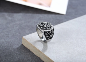 Detail of Viking axe and Vegvisir compass engraving on vintage stainless steel ring