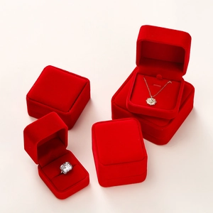 Detailed view of red velvet jewelry boxes for rings and necklaces on light background