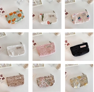 Detailed grid view of assorted French embossed floral cosmetic bags with silver zippers