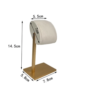 Detailed view of golden watch stand with beige fabric top and precise size measurements