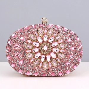 Close-up of pink crystal evening bag featuring floral rhinestone pattern and gold clasp