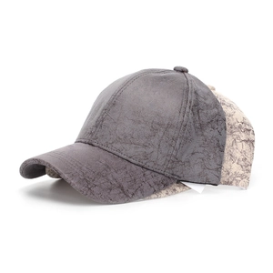 Detailed view of faux suede baseball caps with vintage marble texture and cracked finish