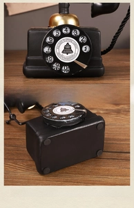 Detail view of American vintage dial phone model with gold trim and non-slip base padding