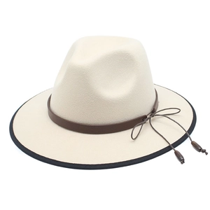 White wool fedora hat with wide brim, brown leather strap, and bead detailing
