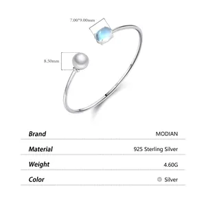 925 sterling silver open bangle with white pearl and blue moonstone setting details