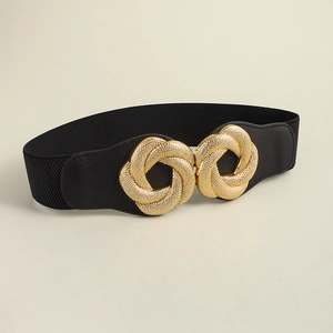 Macro detail of elastic corset belt featuring a large woven textured golden buckle