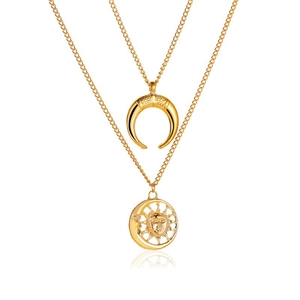 Detail of gold layered necklaces with crescent moon and sun pendants on white background
