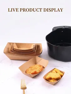 Stackable kraft paper food trays in air fryer with fried chicken on marble background