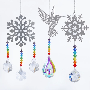 Detailed view of hummingbird and snowflake suncatchers with faceted crystal prisms