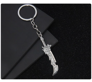 Detailed close-up of a silver metal dragon sword keychain model on a dark background