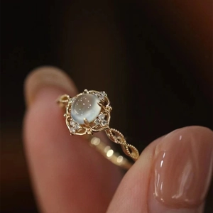 Luxury vintage moonstone ring with intricate gold lace hollow design and twisted band