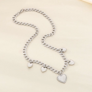 Detail of silver heart pendants on a thick stainless steel chain for women