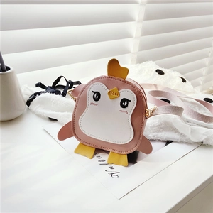 Close-up of cute pink penguin kids shoulder bag with golden zipper and leather texture