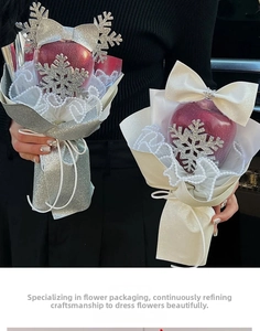 Detail of Christmas apple bouquet holder with lace mesh and sequined snowflake decor