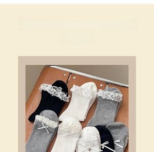 Detailed close-up of casual cotton socks featuring delicate lace trim and ribbon bows