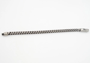 Close-up of vintage silver titanium steel cuban link bracelet with a secure plug-in clasp
