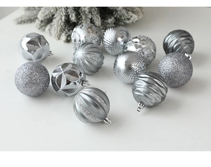 Close-up of 12 silver Christmas balls with glitter, matte and textured finishes on branches