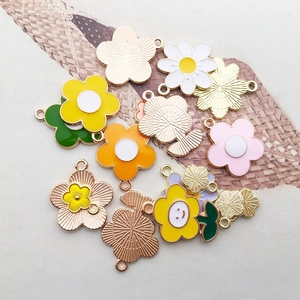Flat lay of colorful alloy floral charms for DIY jewelry making in assorted vibrant colors