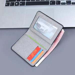 Vertical grey canvas bifold wallet with multiple card slots and transparent ID window