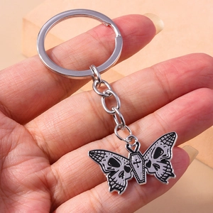 Detailed view of Gothic butterfly keychain featuring skull wings and coffin-shaped body