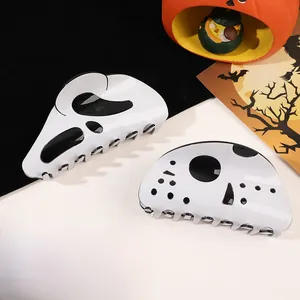 Close-up of Halloween hair claws featuring Scream and Jason mask designs on festive backdrop