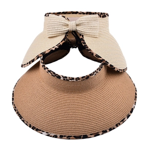 Close-up of women's straw sun visors with leopard print edges and woven bow detail