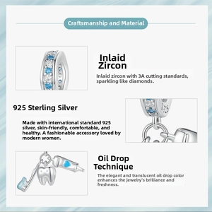 Detailed view of S925 sterling silver toothbrush pendant with blue zircon and enamel work