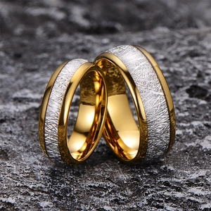 Luxury tungsten steel rings with frosted rime texture and gold edges on grey rock
