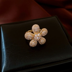Detail of vintage flower ring with white zircons on a luxury black leather jewelry box
