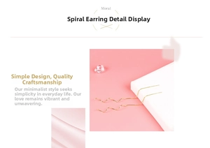 Detail view of gold spiral threader earrings with delicate wave chain design