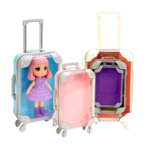 Mini transparent toy suitcase storage boxes in blue, pink, and white with doll accessory
