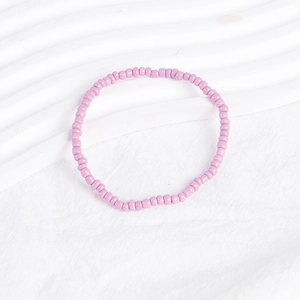 Detailed macro view of soft lavender beaded bracelet with high-gloss glazed finish beads