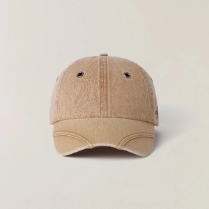 Macro detail of khaki washed cotton twill baseball cap with metal ventilation eyelets