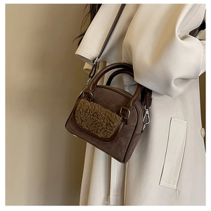 Brown faux suede handbag with khaki faux shearling pocket detail worn with a beige trench coat