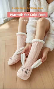 Close-up of pink fleece floor socks featuring cute rabbit ears and warm sherpa lining