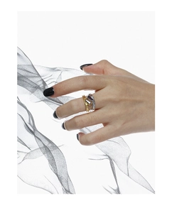 Detailed view of layered S925 silver rings with purple zircons on model hand