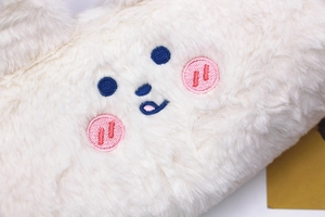Macro shot of cute bear embroidery and soft plush texture on the white pencil case