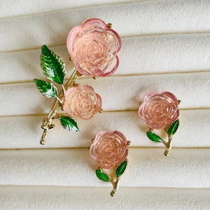 Pink rose jewelry set with enamel green leaves on white velvet tray for women